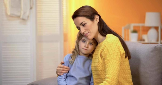 A mother hugging her daughter in her room