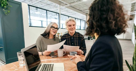 A man and woman sitting across from an estate planning attorney