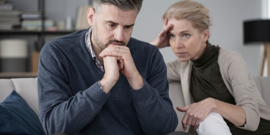 Woman looking at an anxious man