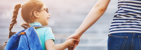 Child holding hands with mom