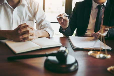 Two people sitting at a lawyer's desk