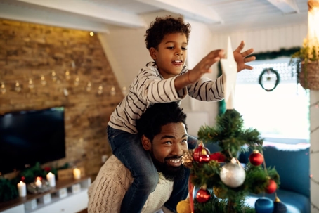 Father and son decorating Christmas tree