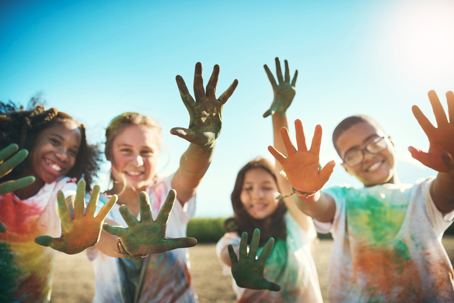 children at summer camp showing painted hands