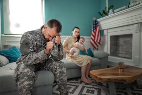 troubled servicemember sitting next to wife and child