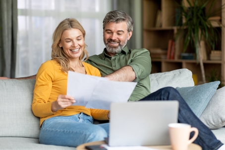 happy couple reviewing documents at home