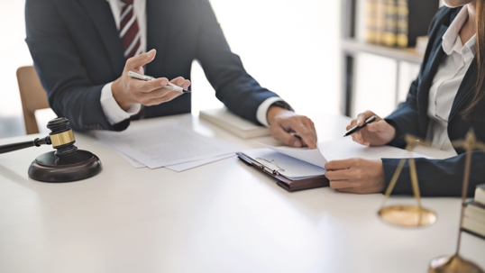 client discussing documents with lawyer