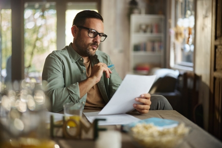 man reading documents at home