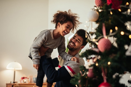 Father and son decorating Christmas tree
