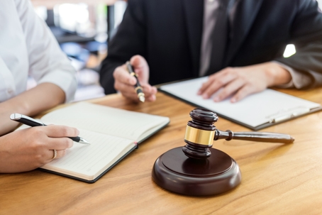 lawyer and client going over notes and documents