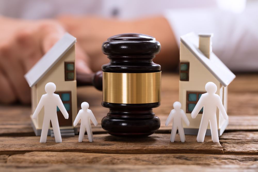 Gavel breaking a fake house